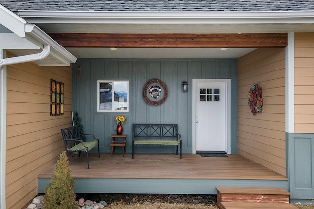 property entrance featuring roof with shingles and board and batten siding