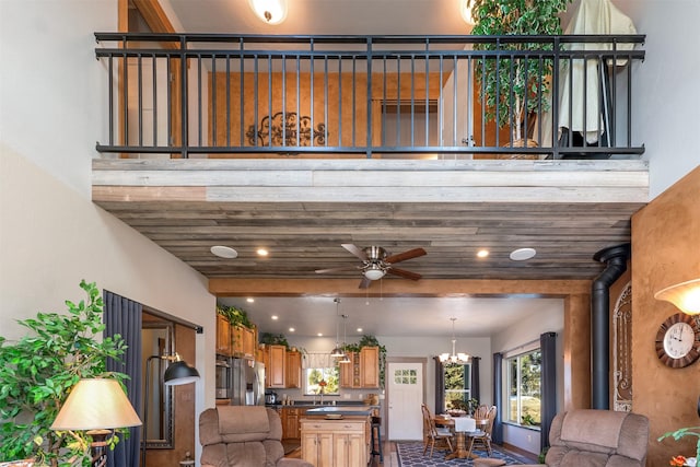 interior space featuring dark countertops, a wood stove, brown cabinetry, and open floor plan