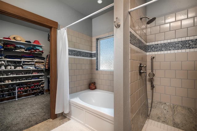 full bathroom with a tub, a spacious closet, and a tile shower