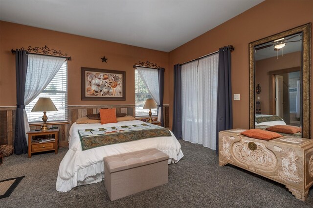 bedroom with carpet flooring and wainscoting