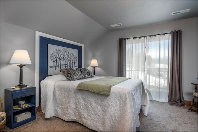 carpeted bedroom featuring visible vents and vaulted ceiling