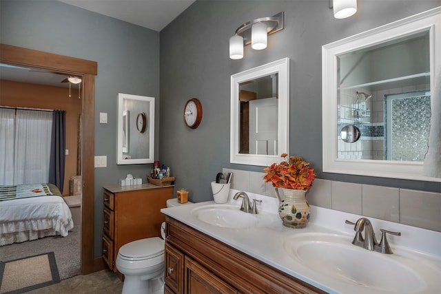 bathroom featuring double vanity, toilet, and ensuite bath