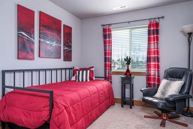 carpeted bedroom featuring visible vents