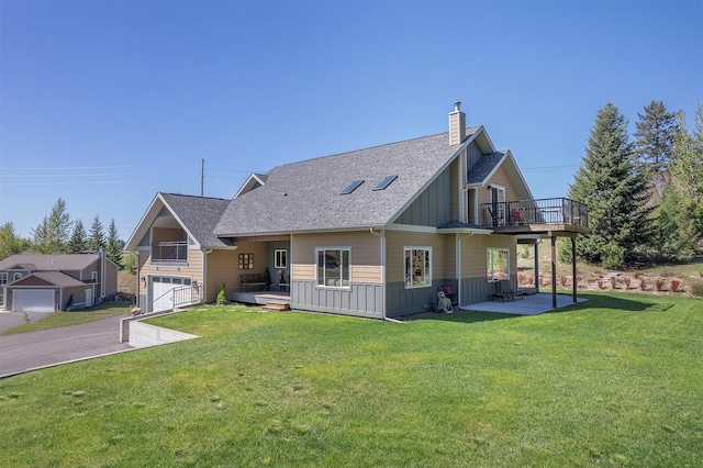view of front of home with a balcony, board and batten siding, a chimney, and a front yard