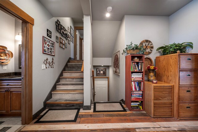 staircase with wood finished floors