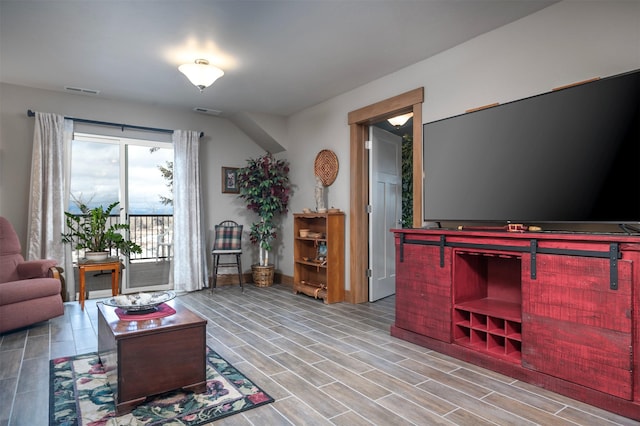 living room with visible vents and wood tiled floor