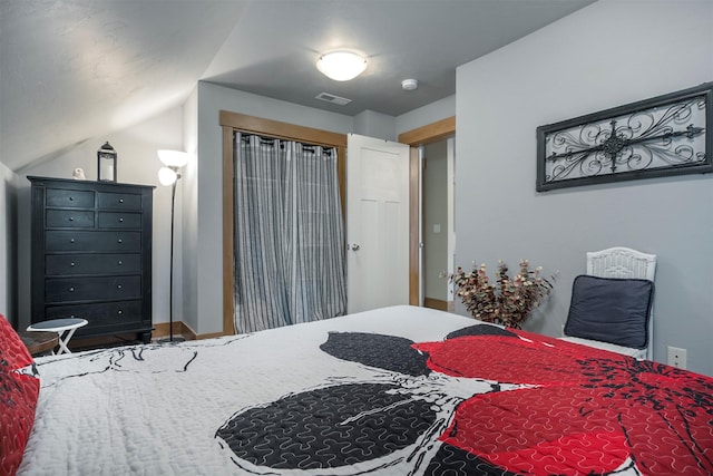 bedroom with lofted ceiling and visible vents