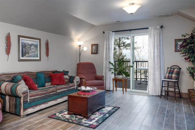 living room featuring lofted ceiling and wood finished floors