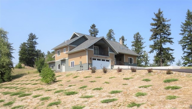 view of side of property featuring a garage and a chimney