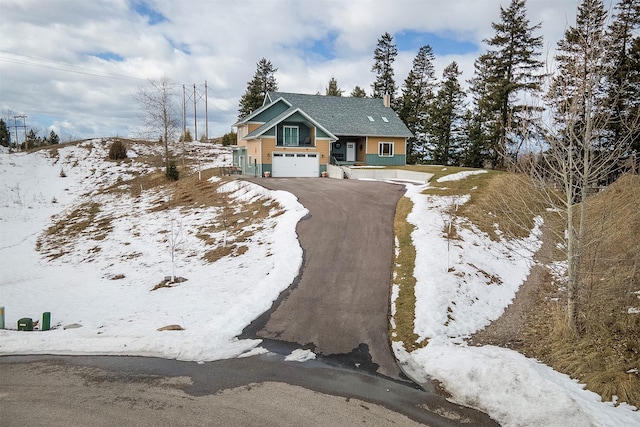 view of front of property with aphalt driveway and a garage