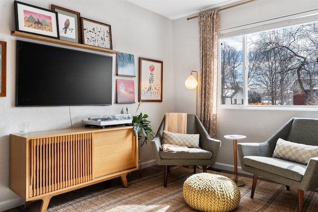 living area featuring baseboards