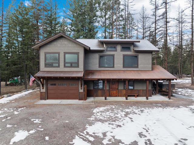 view of front of home with a garage and a porch