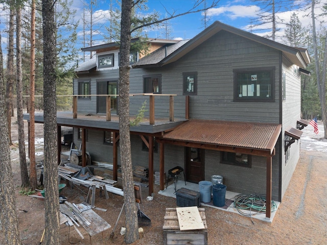 rear view of property with a patio area and a wooden deck