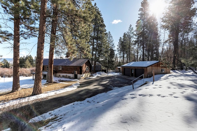 exterior space with a detached garage, an outbuilding, and an outdoor structure