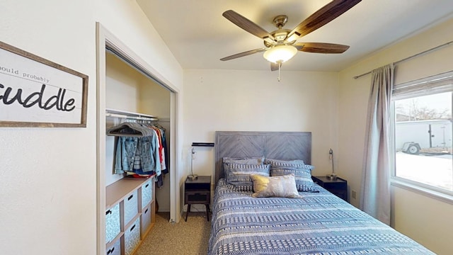 carpeted bedroom featuring a closet, multiple windows, and ceiling fan