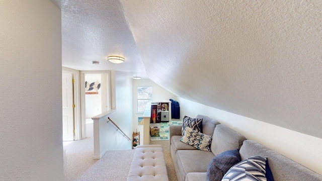 living room featuring lofted ceiling, a textured ceiling, and carpet flooring