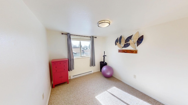 exercise area featuring a baseboard radiator, light carpet, and baseboards