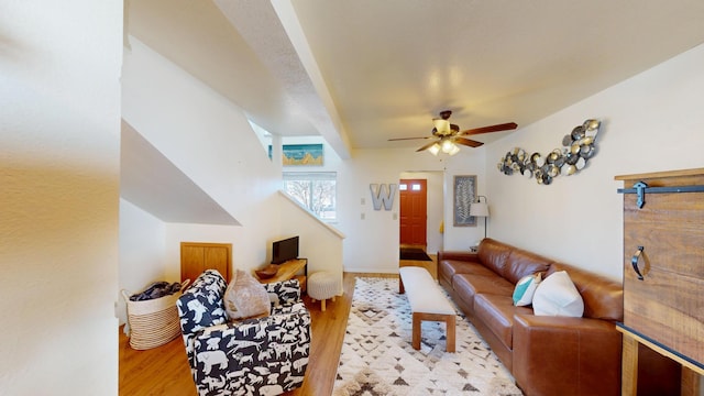 living room with light wood-style flooring and a ceiling fan