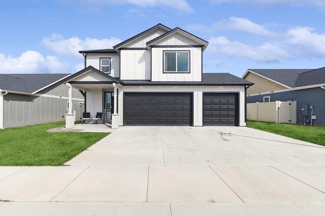 modern inspired farmhouse featuring an attached garage, fence, driveway, board and batten siding, and a front yard