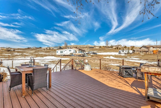 snow covered deck with outdoor dining area