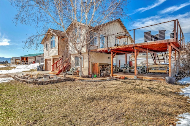 view of front of property featuring an attached garage, a front lawn, and a patio