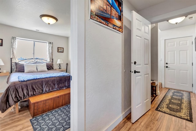 interior space with baseboards and wood finished floors