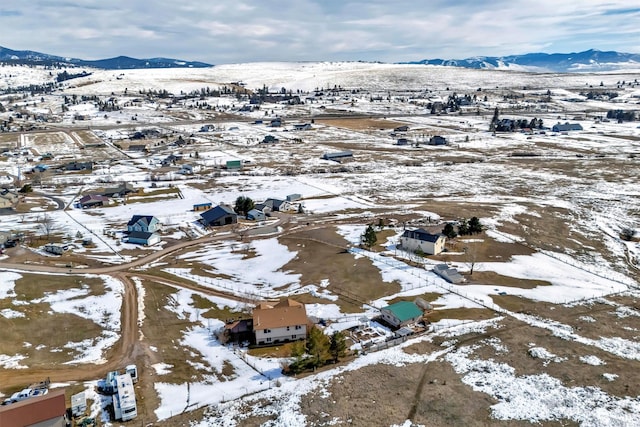 snowy aerial view with a mountain view