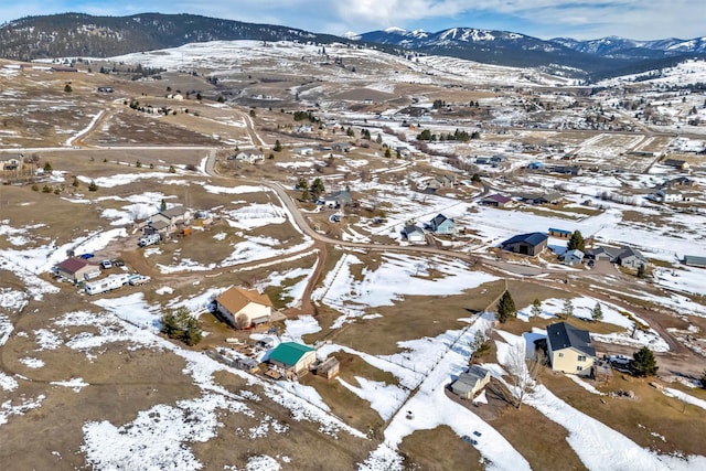 snowy aerial view with a mountain view