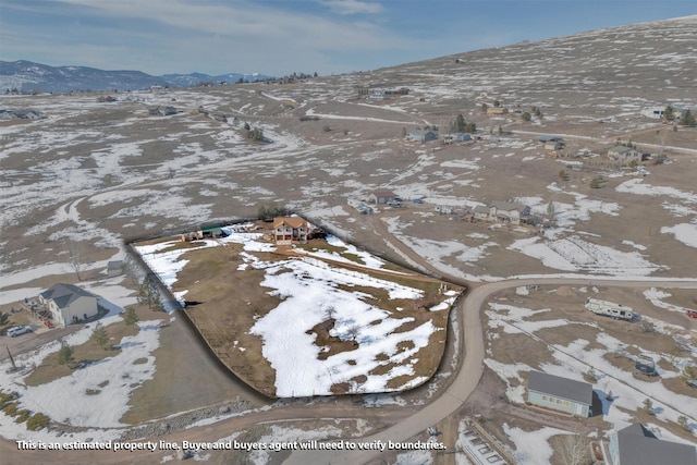 snowy aerial view with a mountain view