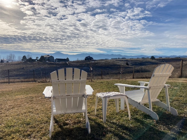 exterior space with fence and a mountain view