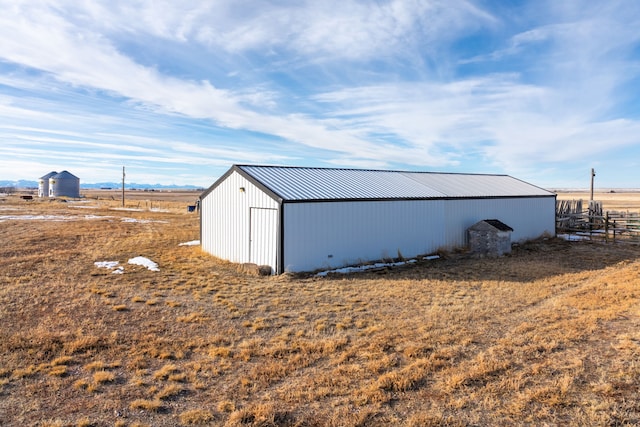 view of pole building with fence