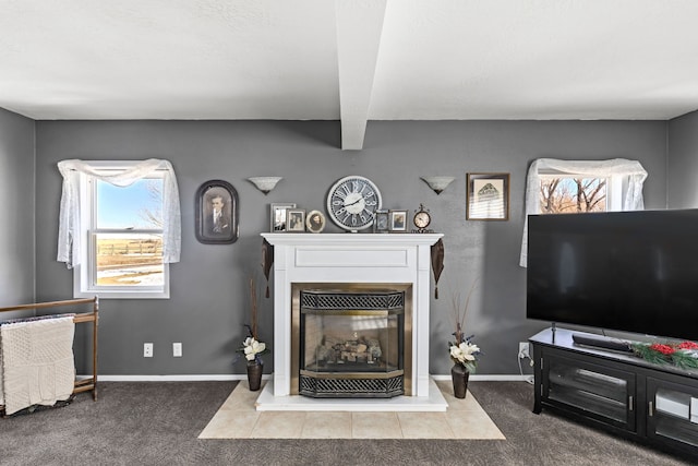 carpeted living area featuring beamed ceiling, a glass covered fireplace, and baseboards