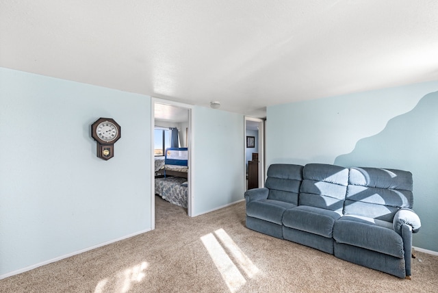 carpeted living area with baseboards