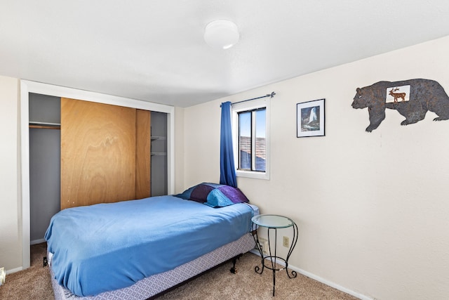 bedroom featuring a closet, carpet flooring, and baseboards