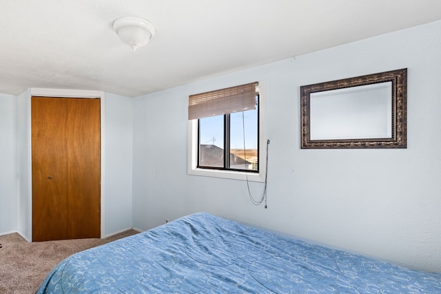 bedroom with carpet floors and baseboards