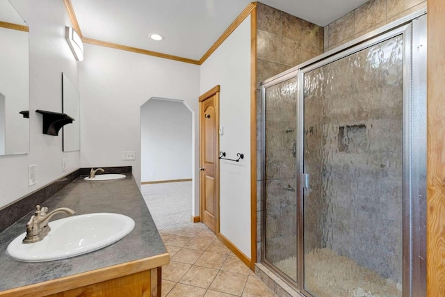 full bathroom with a stall shower, tile patterned flooring, a sink, and crown molding