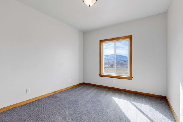 empty room with carpet floors and baseboards