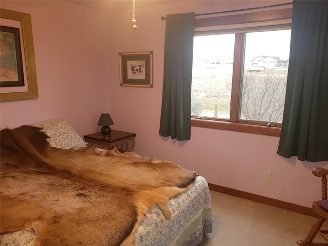 bedroom with carpet flooring and baseboards