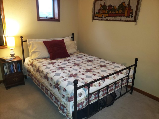 bedroom featuring carpet flooring and baseboards