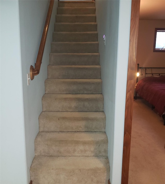 stairs featuring carpet