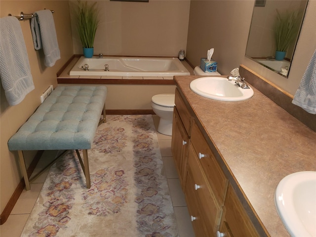 bathroom with tile patterned floors, toilet, a garden tub, and vanity