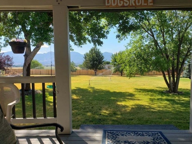 view of yard with fence and a mountain view