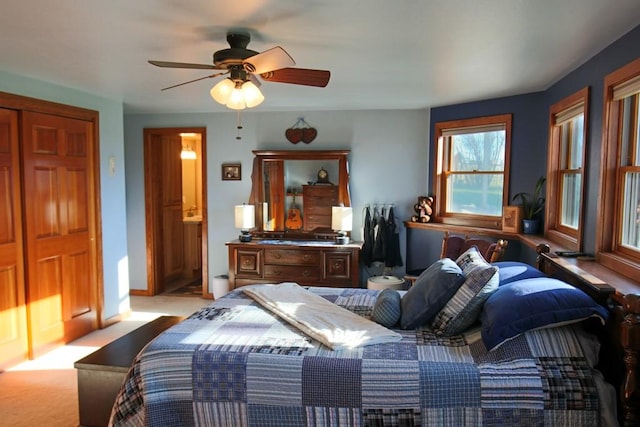 carpeted bedroom with baseboards and a ceiling fan