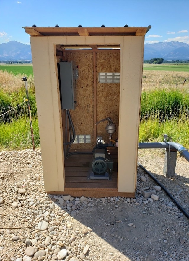 view of outbuilding with a rural view and a mountain view