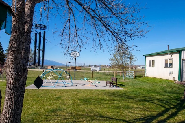 view of yard with a playground and fence