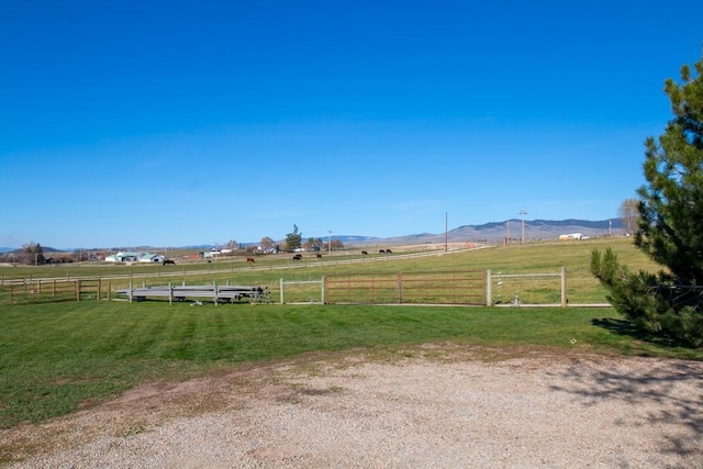 exterior space featuring a rural view and fence