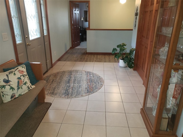 entryway featuring tile patterned flooring and baseboards