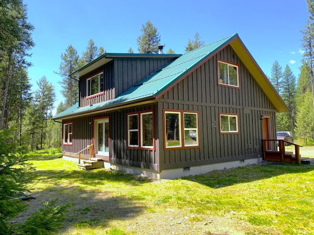 rear view of house with metal roof, french doors, crawl space, and board and batten siding