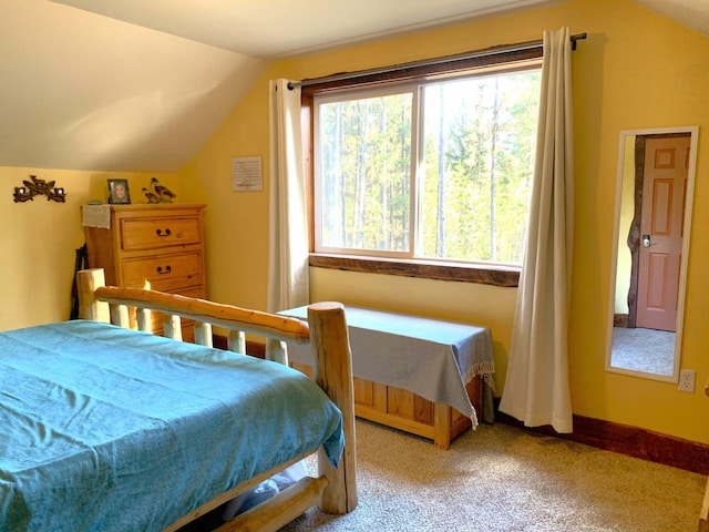 bedroom featuring lofted ceiling, carpet flooring, and baseboards