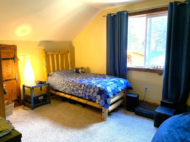 bedroom with lofted ceiling and carpet floors